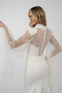 Mermaid dress with accessorized embroidery and flared sleeves