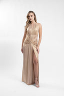 Long golden dress with sculptural drapes and front slit