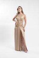 Long golden dress with sculptural drapes and front slit