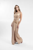 Long golden dress with sculptural drapes and front slit
